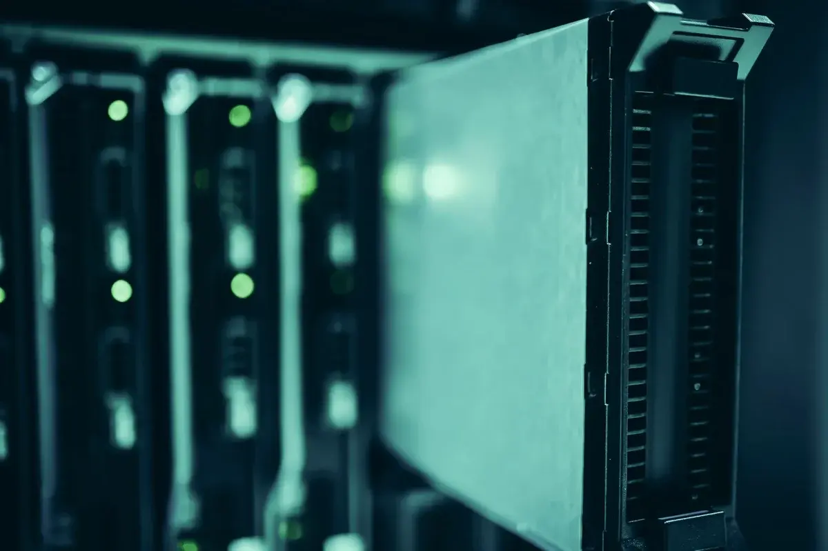 Close-up of server racks with glowing indicator lights in a data center.