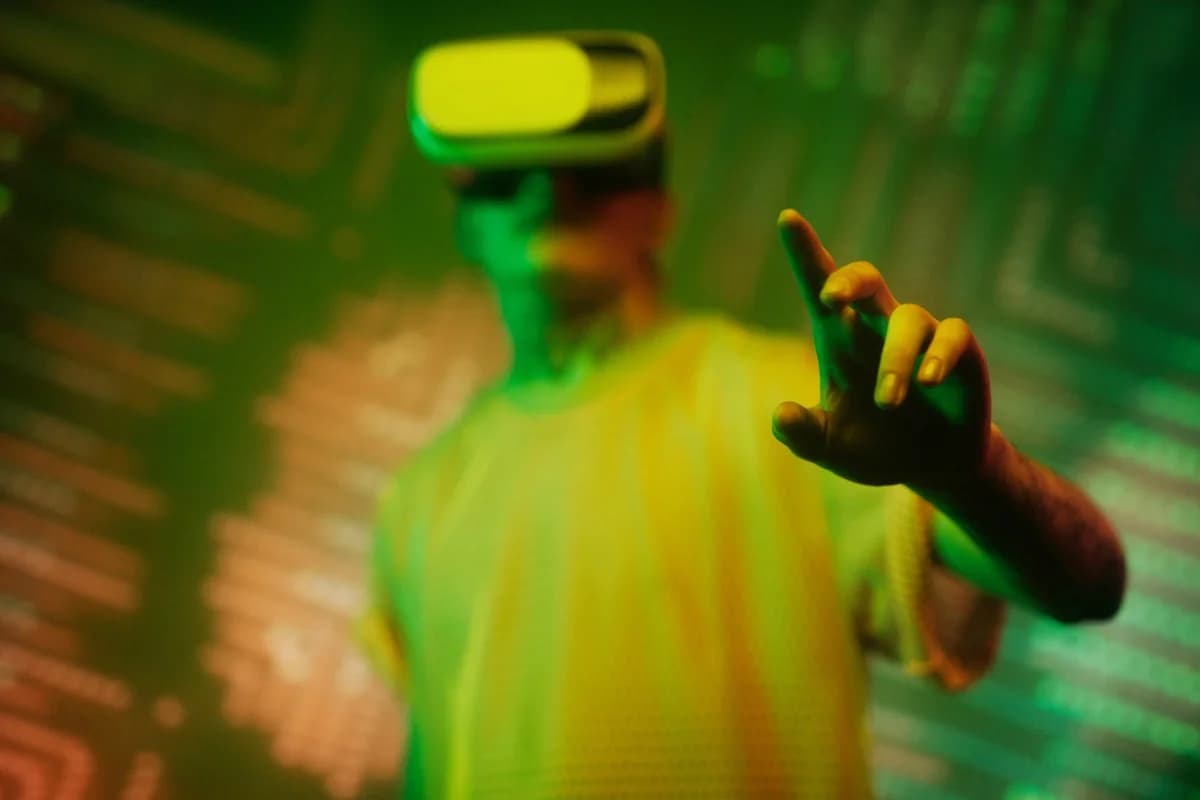 A man uses a VR headset in a futuristic green-lit scene.