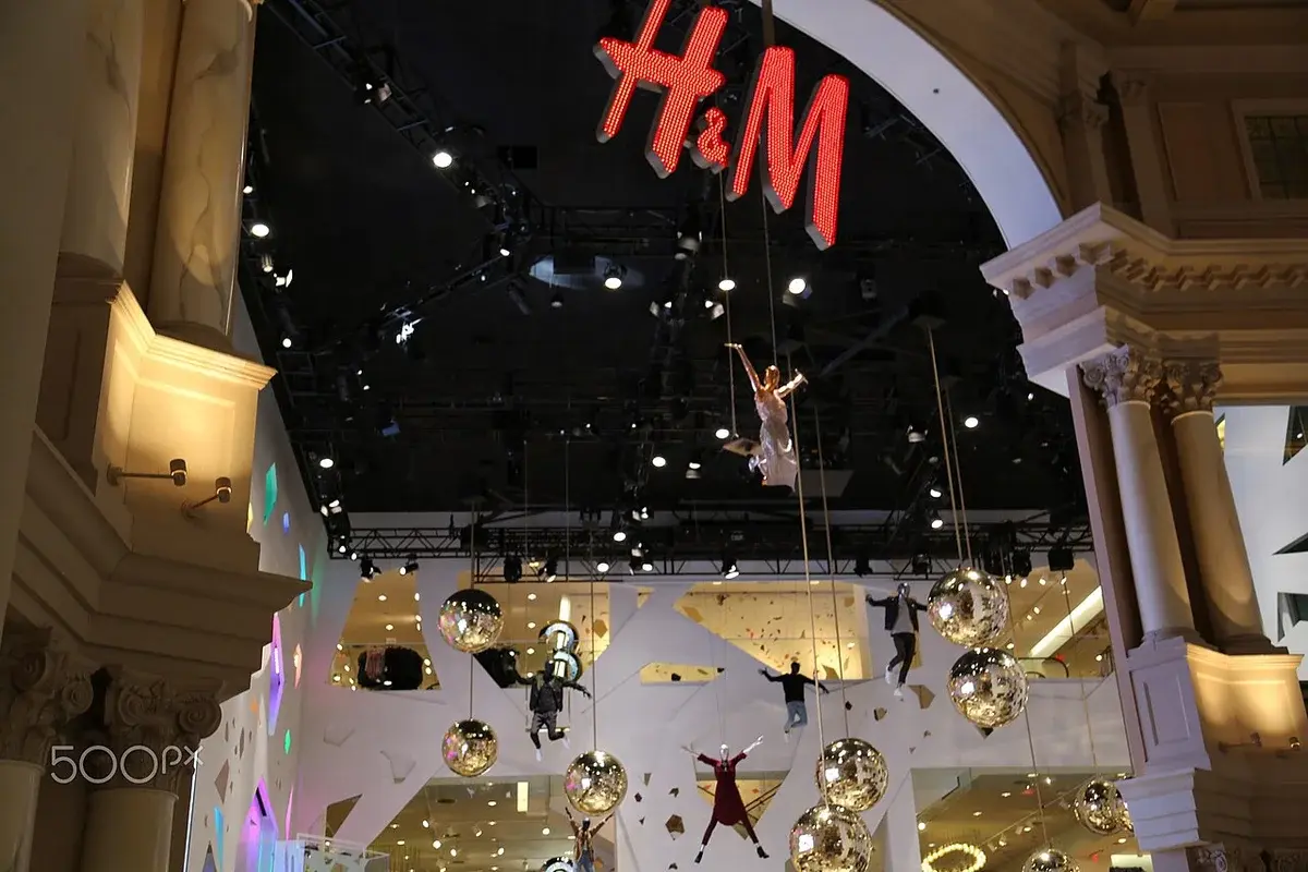 H&M store interior at Caesars Palace in Las Vegas with a large red H&M sign and hanging decorations.