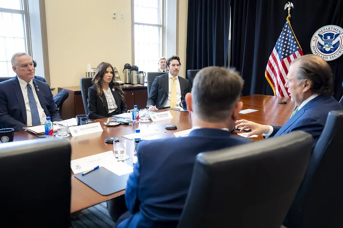 Officials seated around a conference table during a Homeland Security meeting.