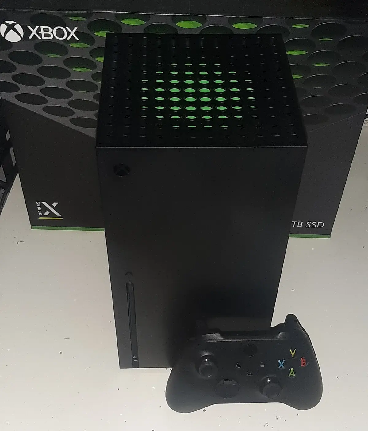 Xbox Series X console with controller in front of the box