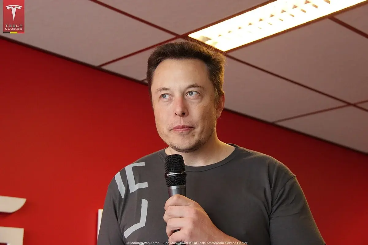 Elon Musk speaking at a Tesla event.