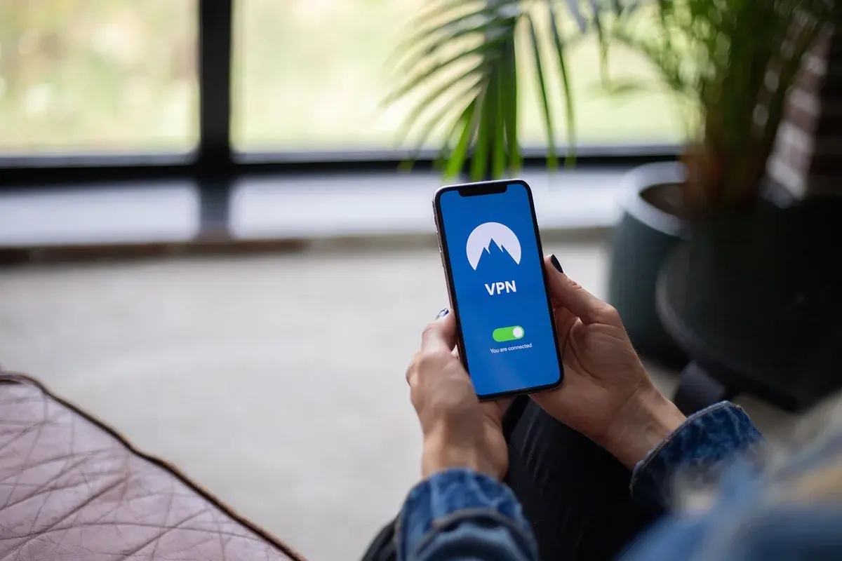 A person holding a smartphone showing a VPN connection screen.