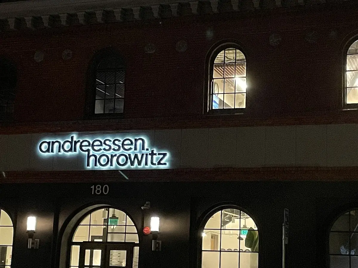 Night view of the Andreessen Horowitz office building lit up in San Francisco.
