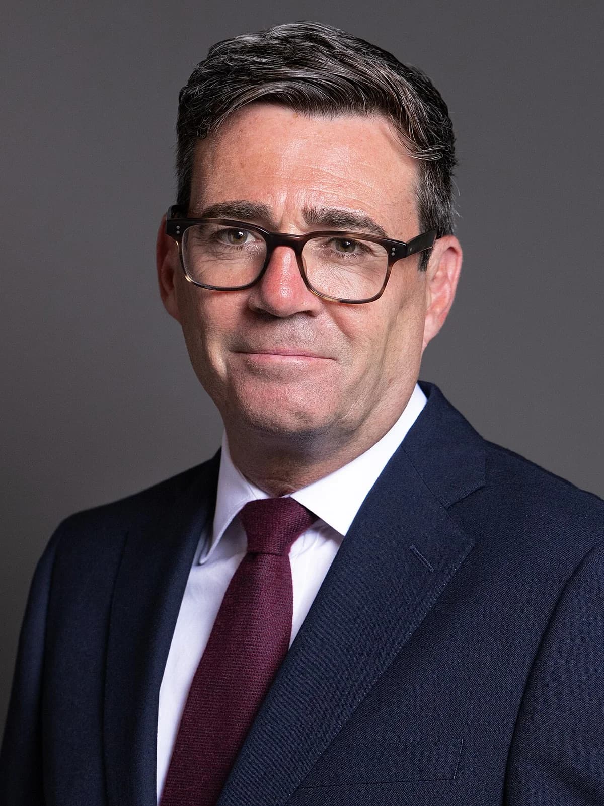 Portrait of Andy Burnham in a suit and tie.