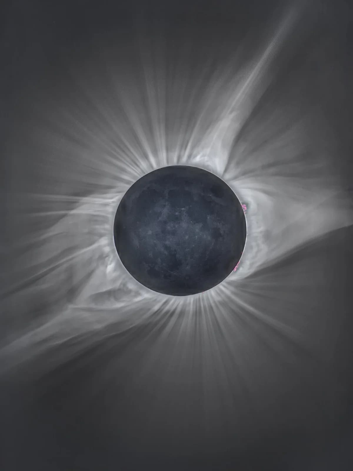 Composite image of a total solar eclipse with the corona visible around the moon.