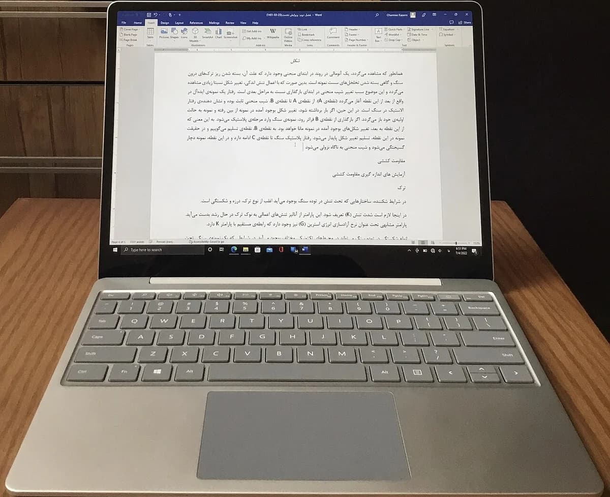A platinum Microsoft Surface Laptop Go laptop open on a desk.