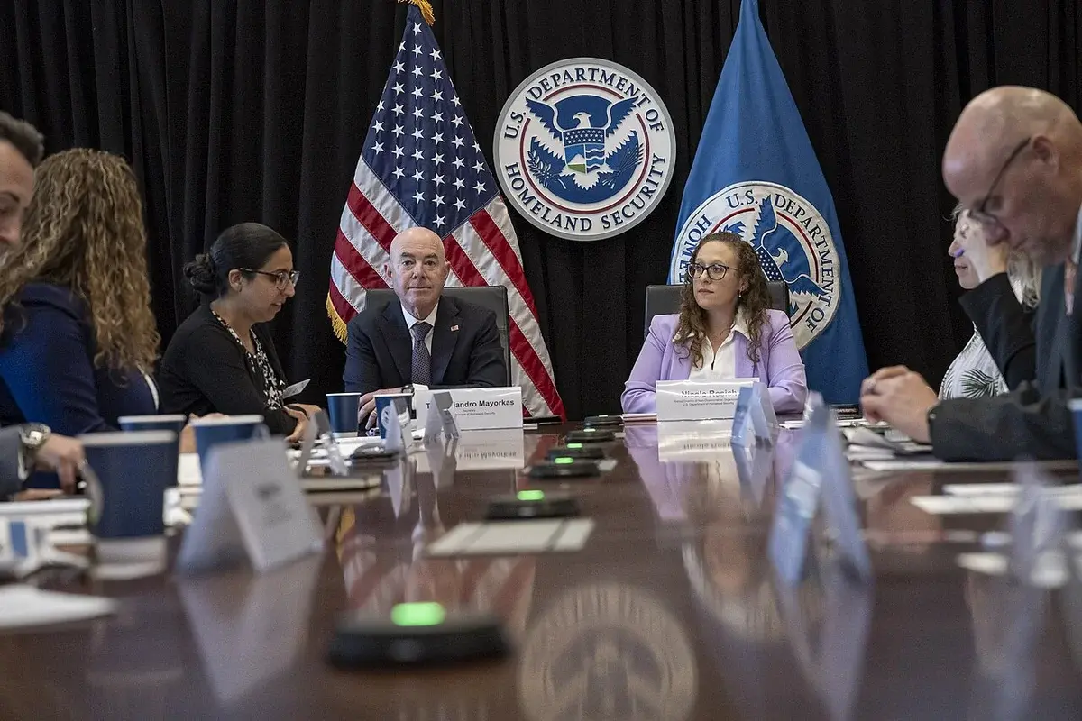 U.S. Department of Homeland Security officials at a conference table during an official meeting.