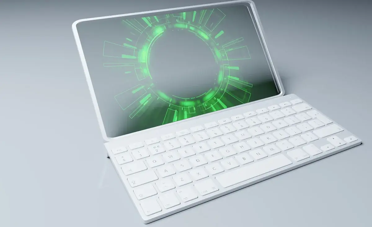 A white tablet displaying a neon-green futuristic interface beside a white keyboard.