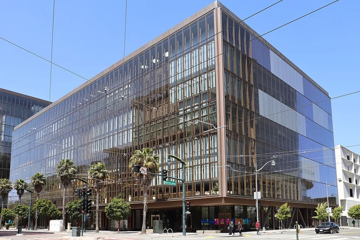 Glass office building in San Francisco identified as OpenAI headquarters.