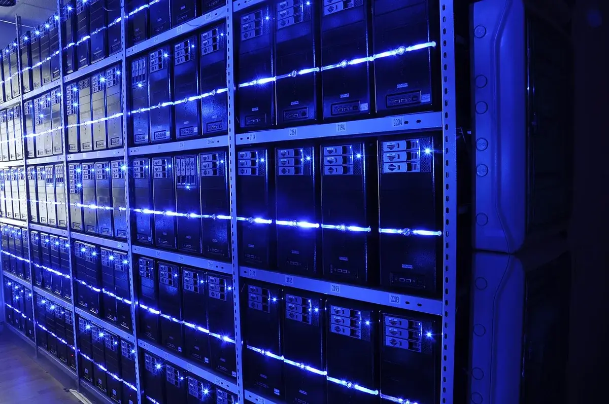 Rows of server racks in a blue-lit data center.