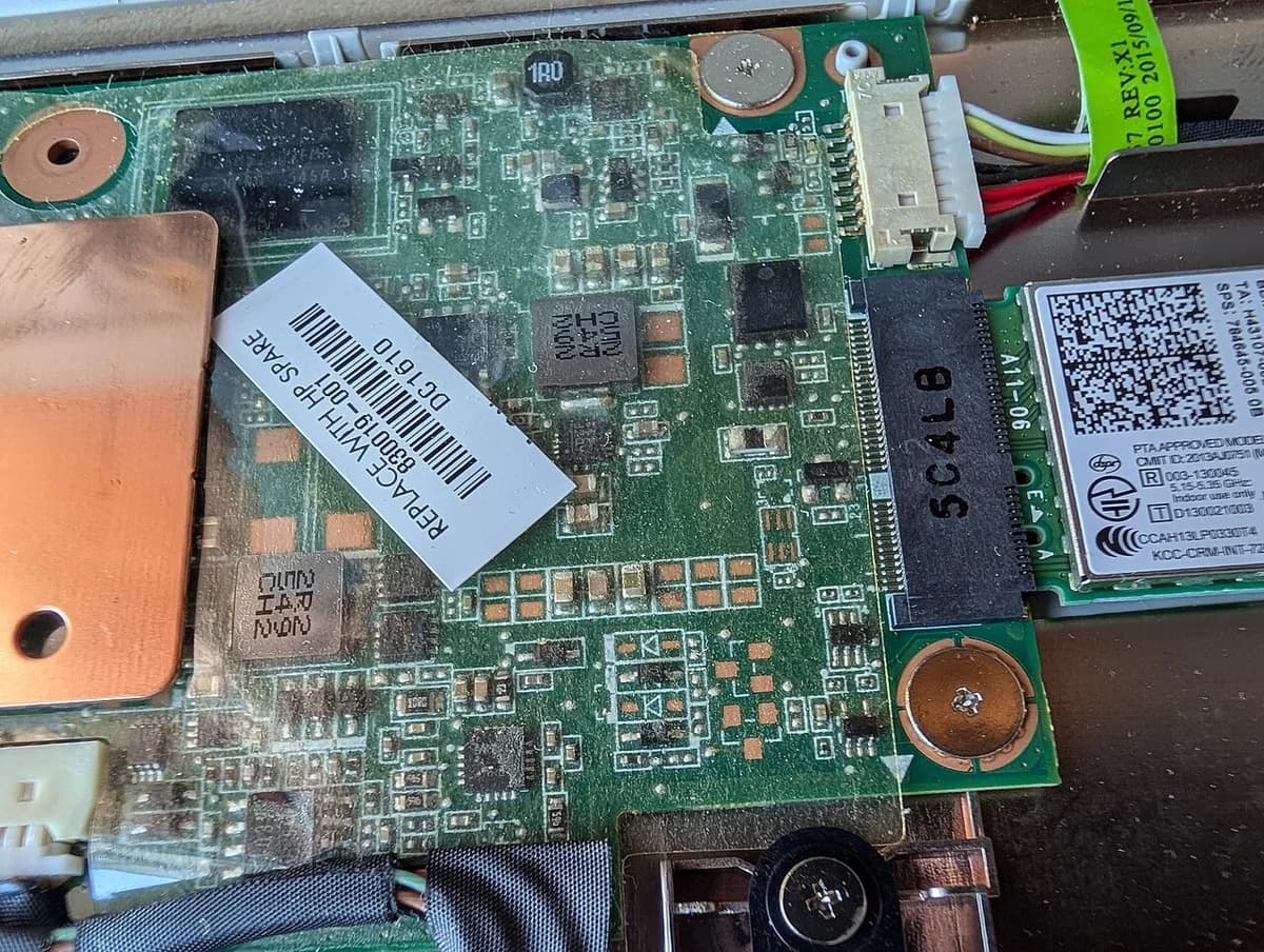 Close-up of a Chromebook motherboard with connectors and chips.