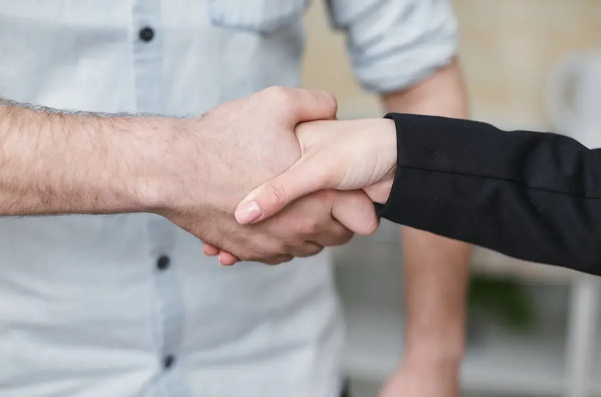Close-up of two people shaking hands.
