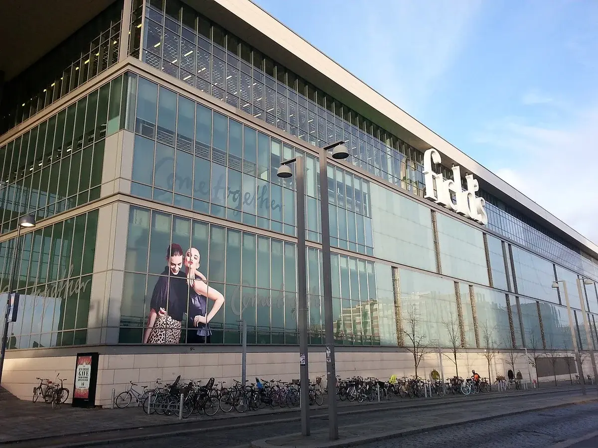 Exterior of the Field's shopping center in Copenhagen with bicycles parked outside.