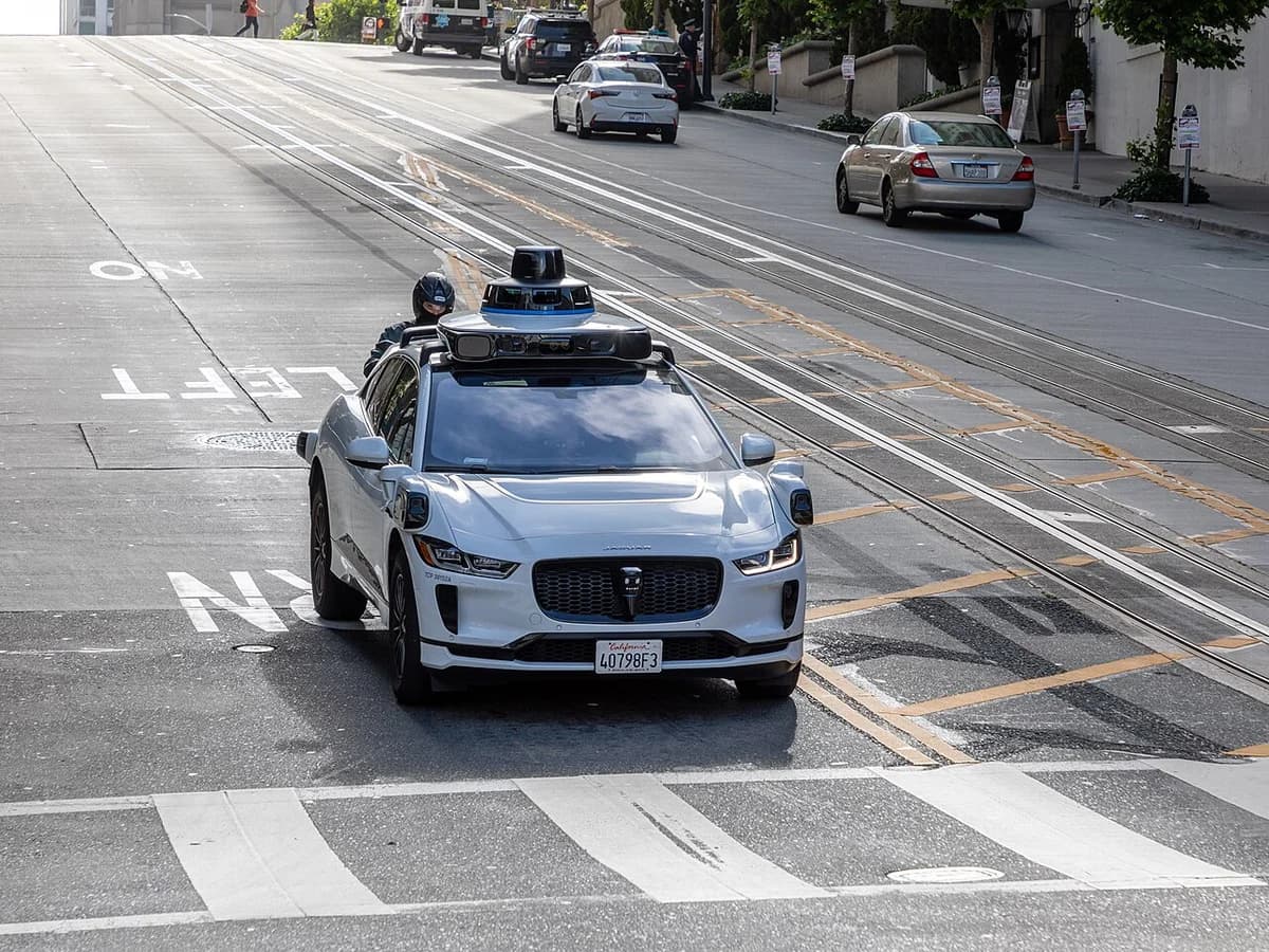 A Waymo self-driving car driving on a San Francisco street.