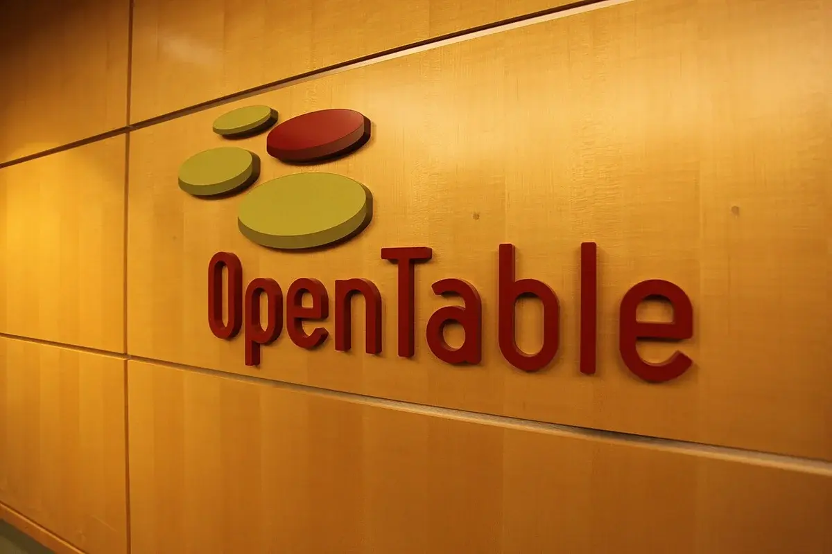 OpenTable logo on a wall sign in an office lobby