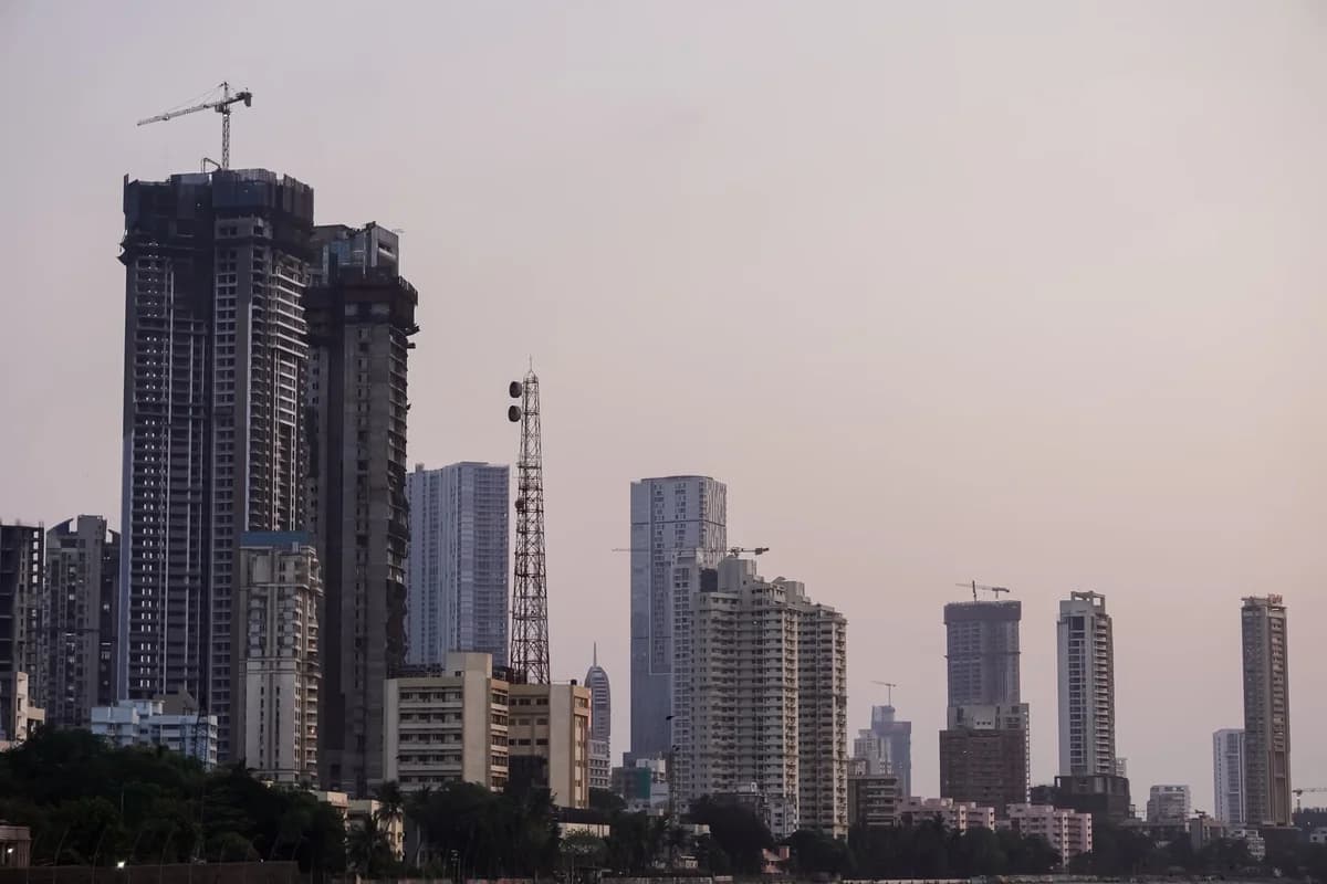 Twilight view of Mumbai high-rise buildings and cranes.