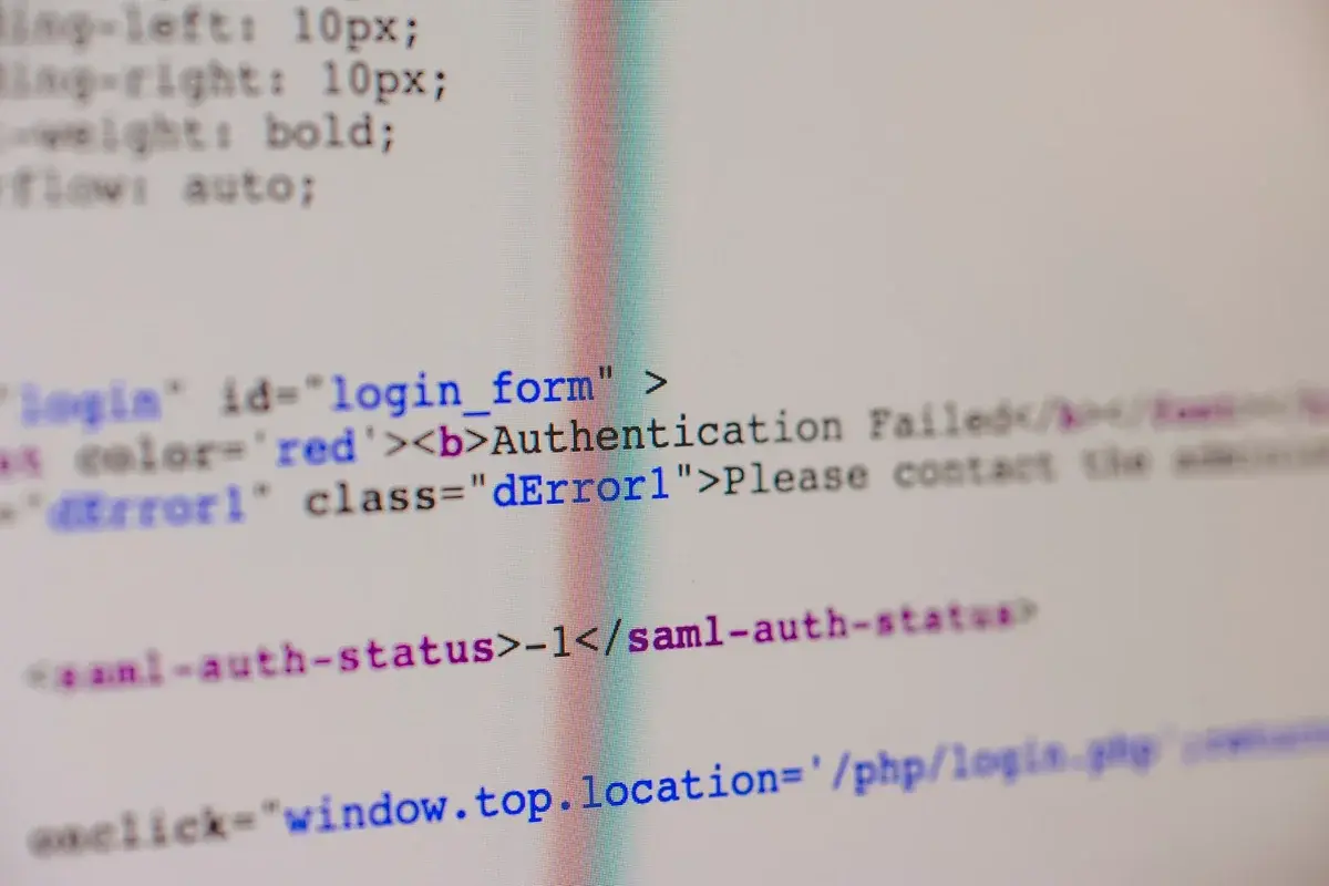 Close-up of HTML and PHP code on a screen with an authentication failed message.