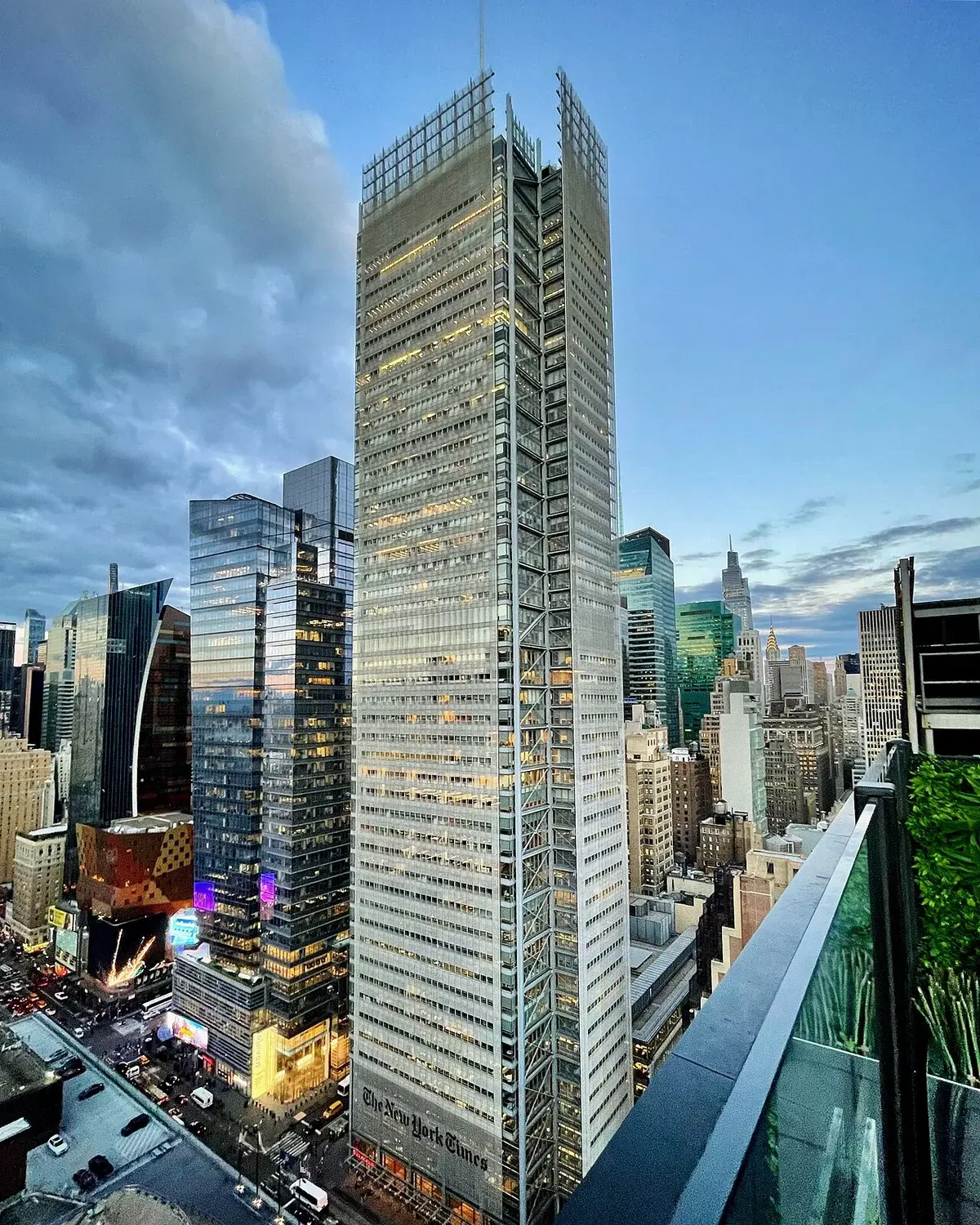 The New York Times Building in New York City at sunset, seen from a nearby rooftop.